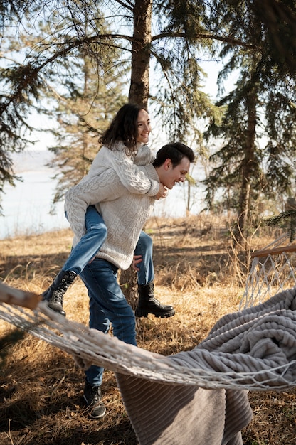 Free photo full shot happy man carrying woman