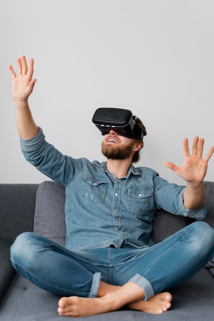 Full shot happy man with vr glasses