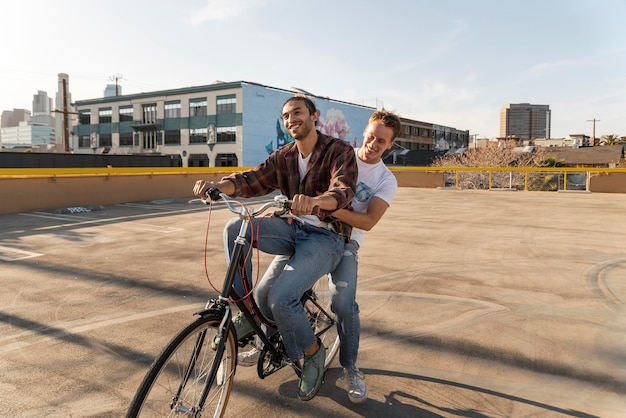 Full shot happy men riding bicycle