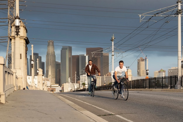 Full shot happy men riding bicycles