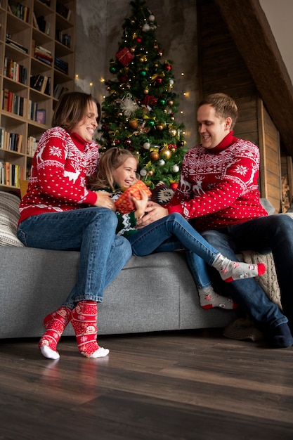 Full shot happy parents and kid at home