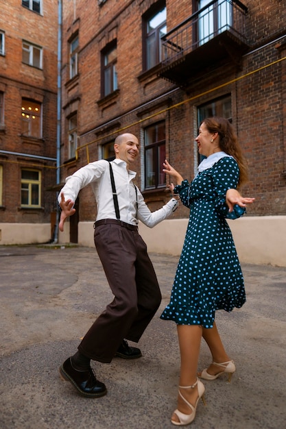 Full shot happy people dancing together