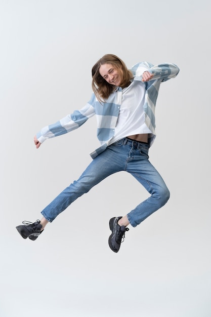 Free Photo full shot happy teenager jumping