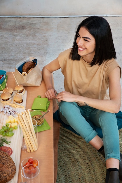 Free photo full shot happy woman sitting on floor