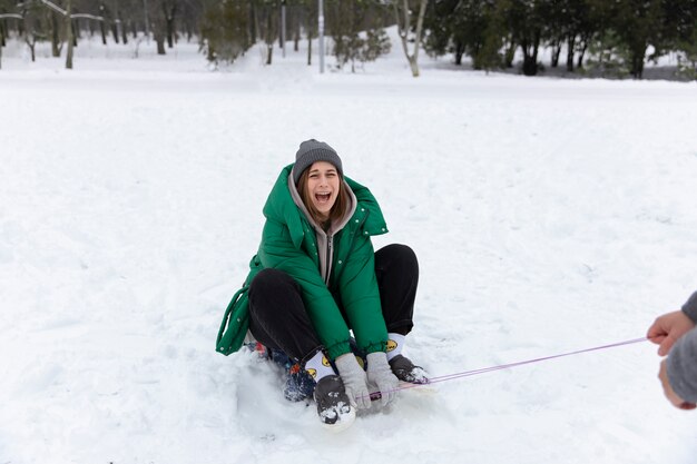 Full shot happy woman on sleigh