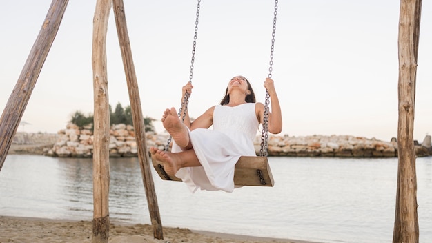 Free photo full shot happy woman in swing