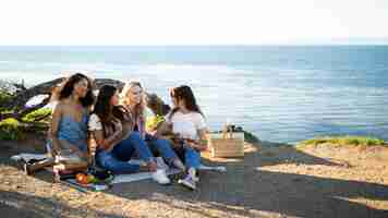 Free photo full shot happy women at picnic outdoors