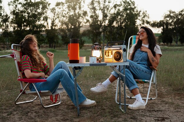 Full shot happy women sitting on chairs