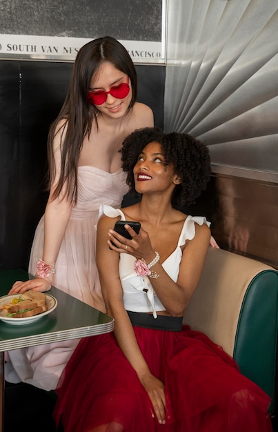 Full shot happy women sitting at table