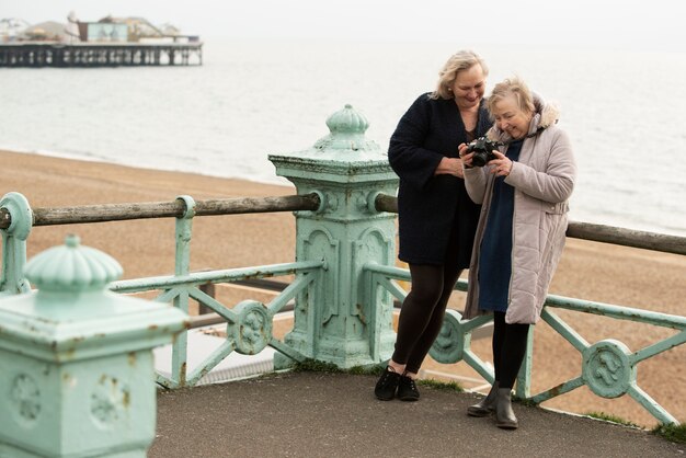 Full shot happy women with camera