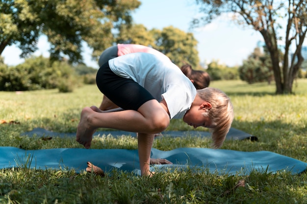 Full shot kid doing yoga