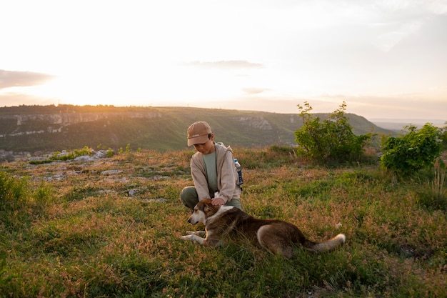 Free Photo full shot kid exploring nature with dog