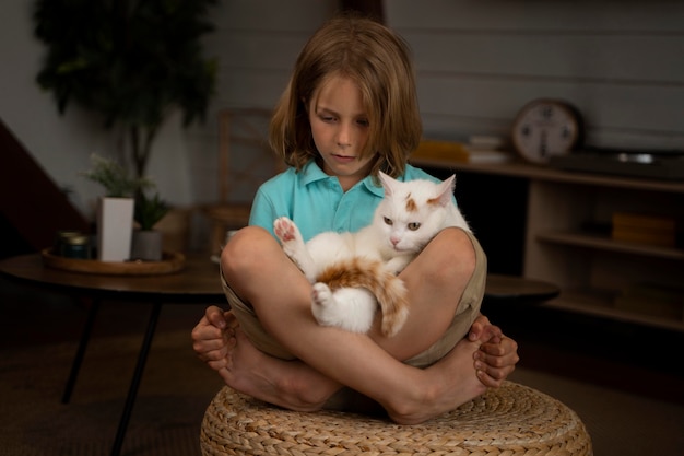 Full shot kid holding adorable cat