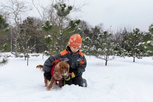 Full shot kid holding dog winter time