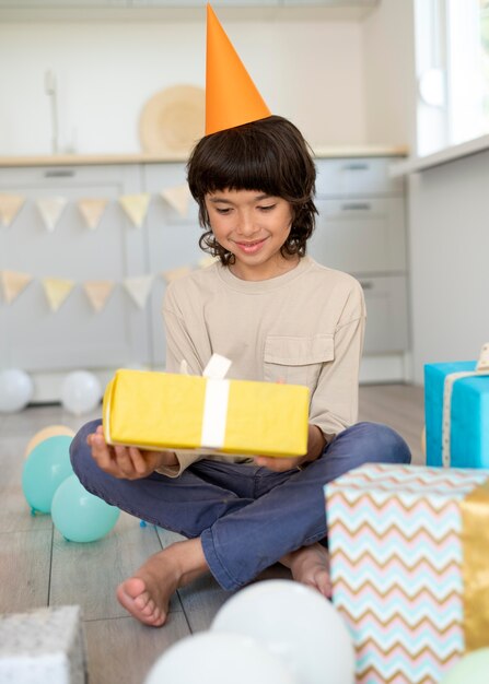 Full shot kid holding present