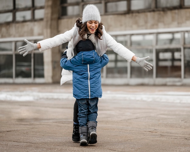 Free Photo full shot kid hugging woman