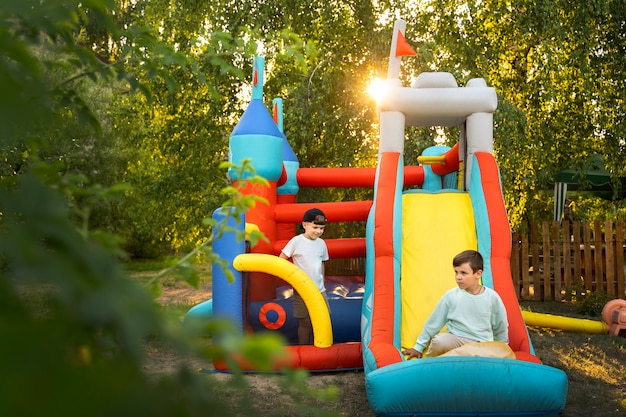 Full shot kid playing in bounce house