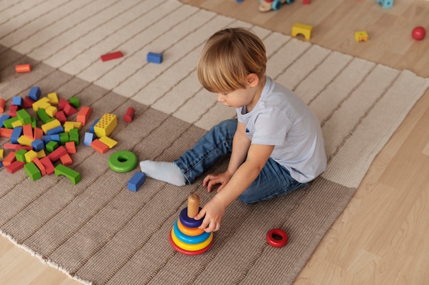 Full shot kid playing on floor