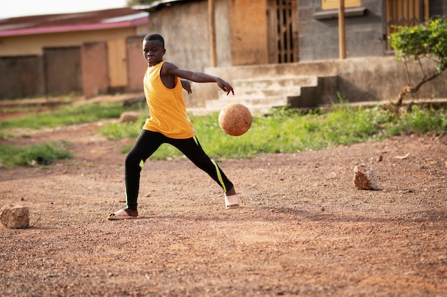 Full shot kid playing with ball