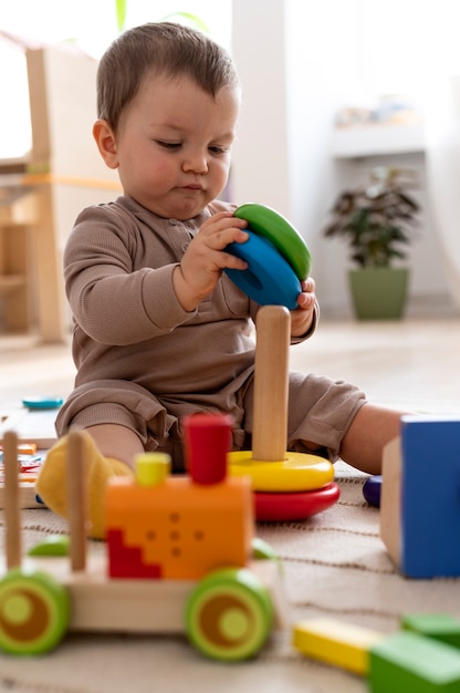 Full shot kid playing with colorful toys