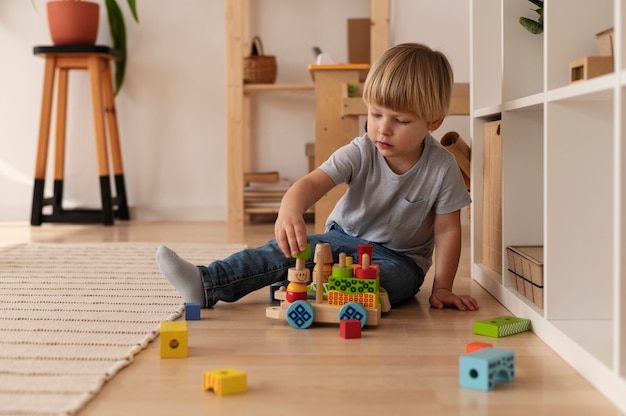 Full shot kid playing with wooden toy at home