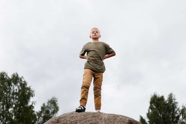 Free Photo full shot kid on rock