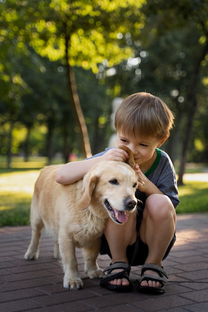 Full shot kid smelling dog