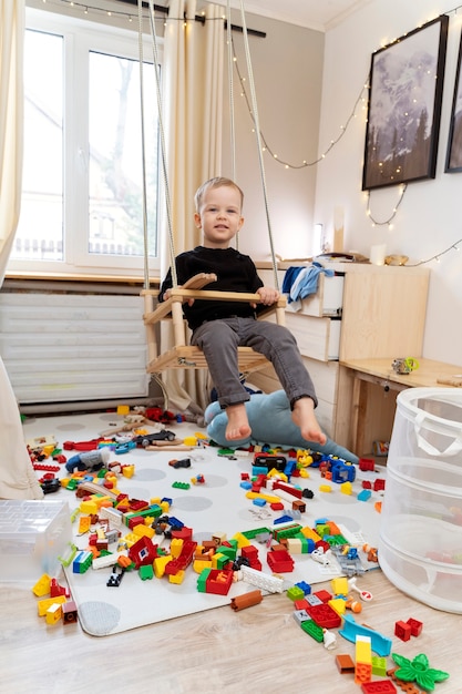 Full shot kid in swing at home