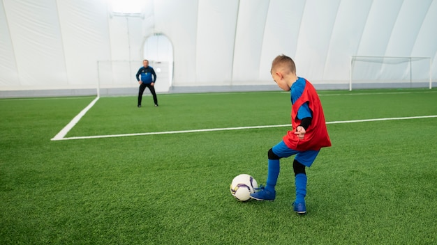 Full shot kid training with ball