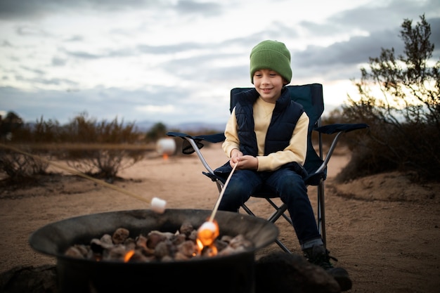 Full shot kid with marshmallow