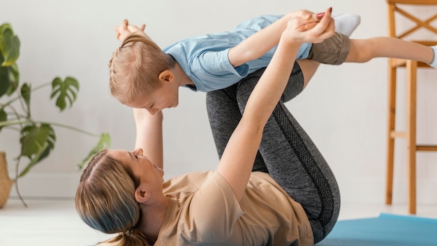 Full shot kid and woman exercising