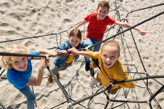 Free photo full shot kids  climbing rope