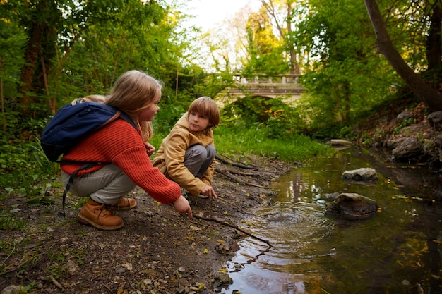 Free photo full shot kids exploring nature together