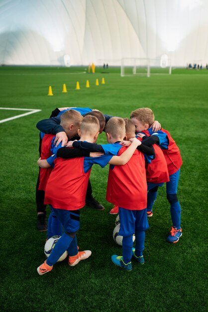 Full shot kids gathering on field