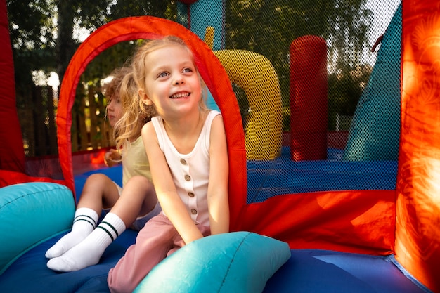 Free photo full shot kids laying in bounce house