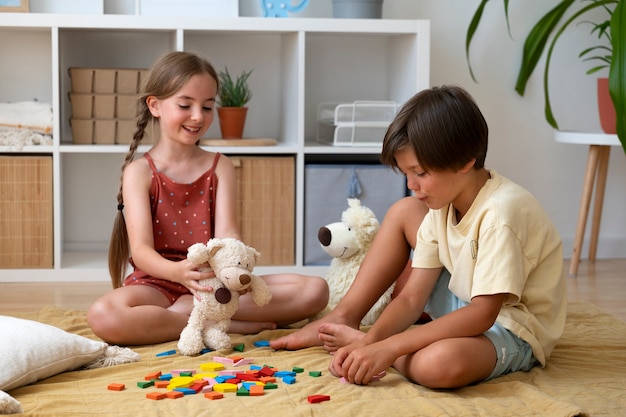 Full shot kids making puzzle indoors