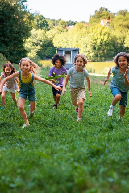 Full shot kids running outdoors