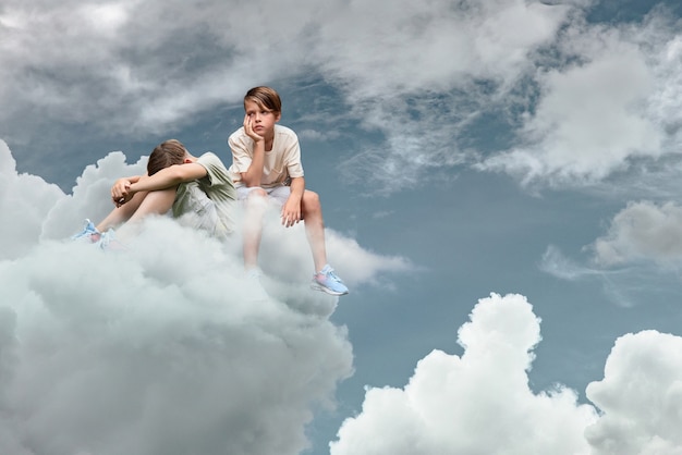 Free Photo full shot kids thinking on clouds