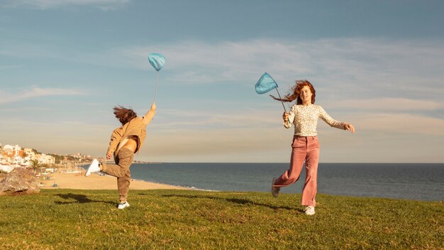 Full shot kids with butterfly net