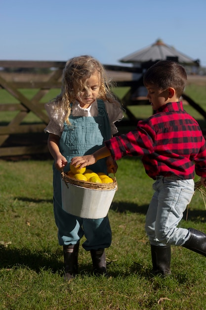 Free Photo full shot kids with fruits