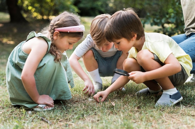 Full shot kids with magnifying glass