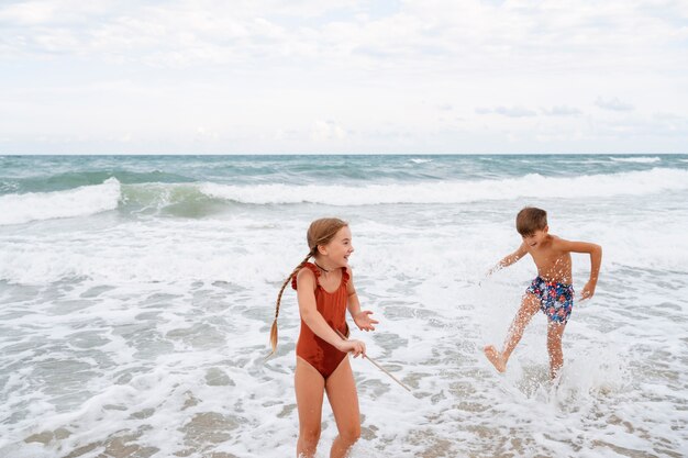 Full shot little kids having fun at the beach