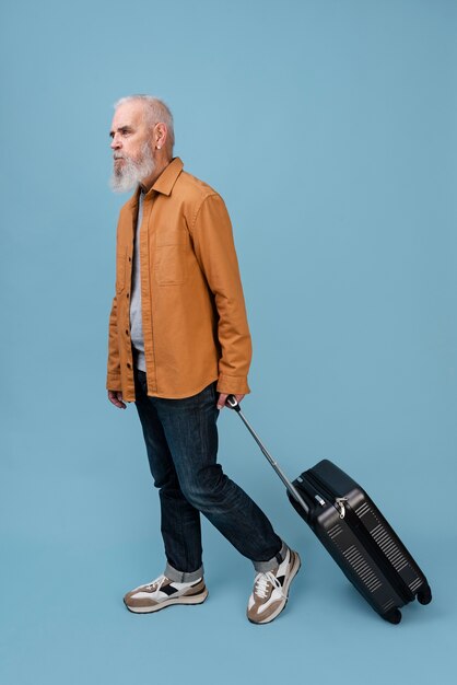 Full shot man carrying dark baggage