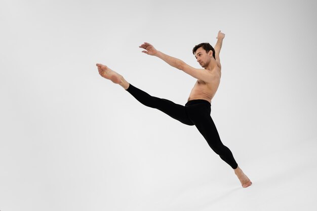 Full shot man dancing in studio