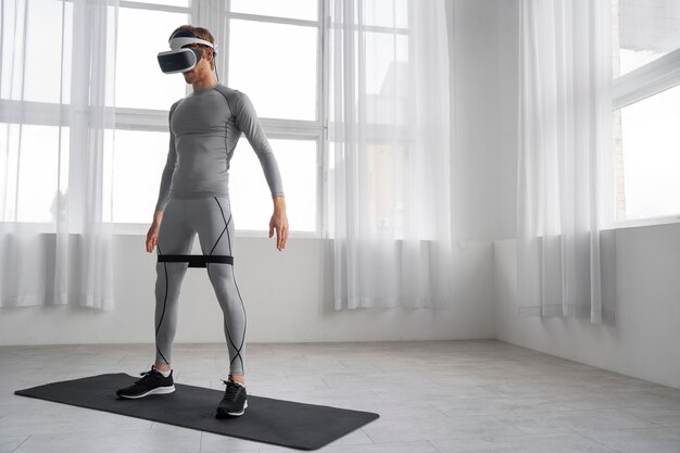 Full shot man doing fitness with vr glasses