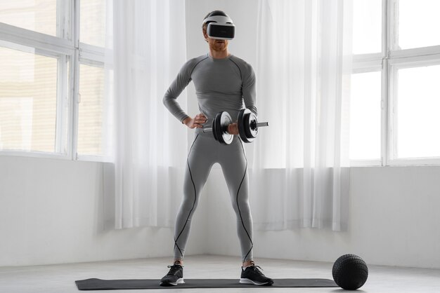 Full shot man doing fitness with vr glasses