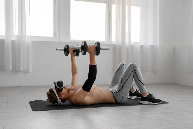 Full shot man doing fitness with vr glasses