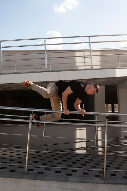 Free photo full shot man doing  parkour training