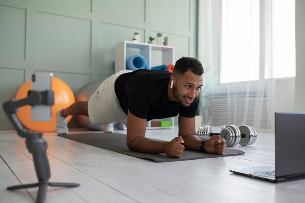 Full shot man doing plank