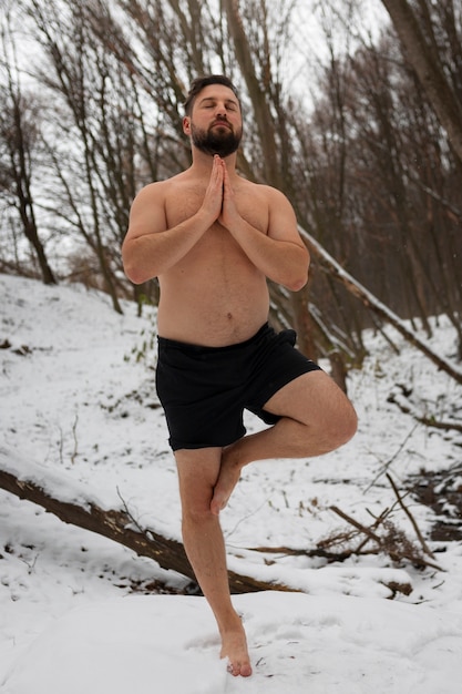 Full shot man experiencing cold exposure for wellness